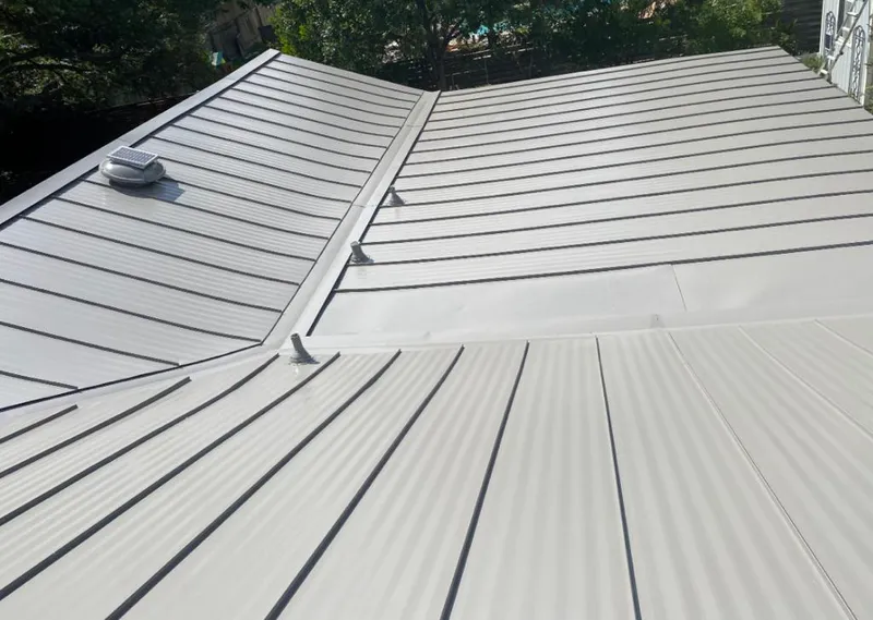 Solar attic fan installed on a metal roof for Roof Ventilation in Forest Grove
